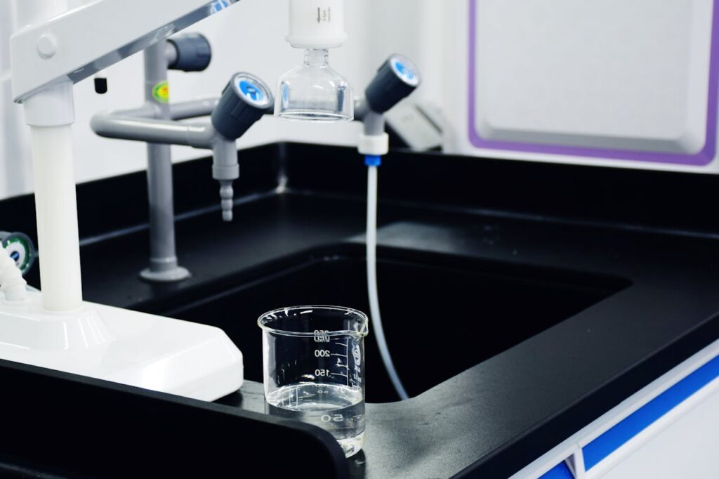 Clear Glass Beaker on the Sink